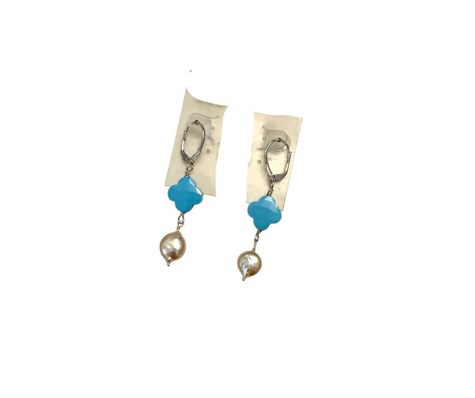 Pair of earrings with blue and pearl-like stones on a white background