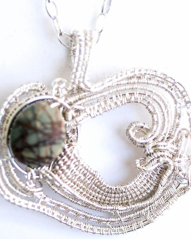 Jasper picture natural stone in a fine silver handwoven frame on a sterling silver chain.