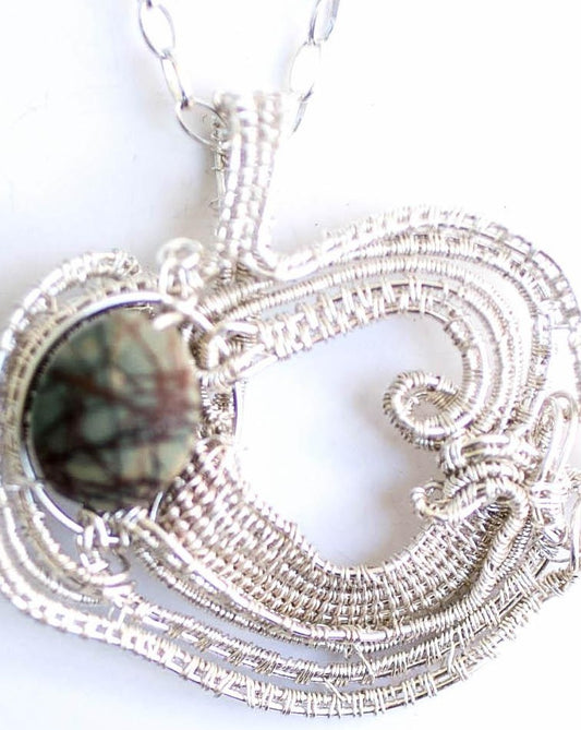 Jasper picture natural stone in a fine silver handwoven frame on a sterling silver chain.