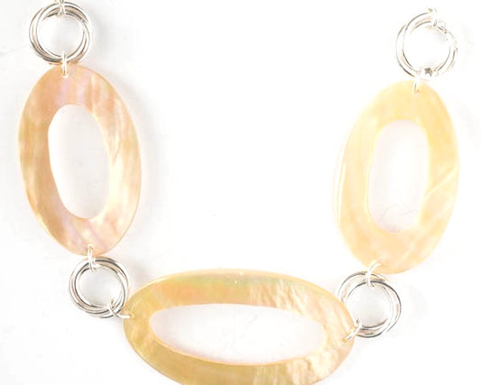 Oval Mother of Pearl shape connected with sterling silver circles on an adjustable chain.