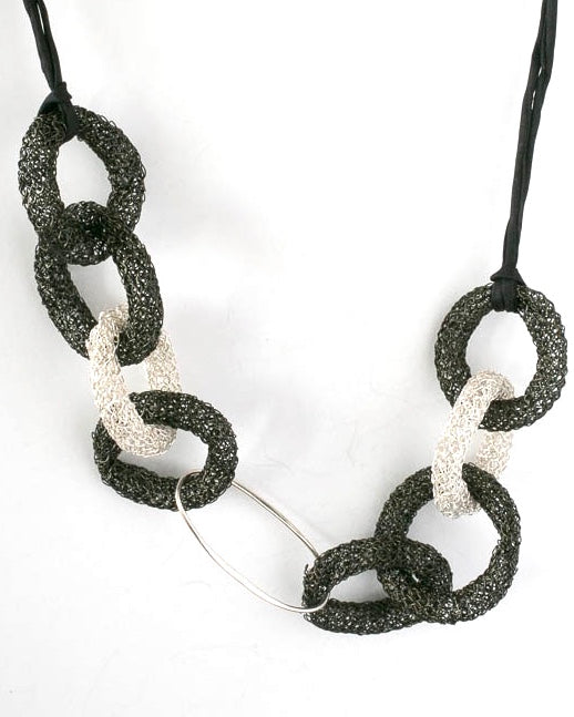 Black and Fine Silver interlooping circles on a silk ribbon for an adjustable length.