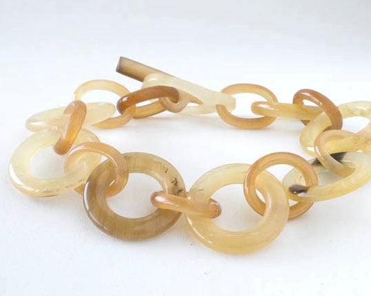 Light natural horn link bracelet with toggle clasp. it is 7 3/4 inches long.
