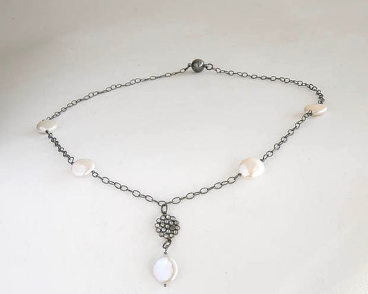 Fresh water coin pearls with sapphire floral accent on an oxidized sterling silver chain. It is 20 inches long.