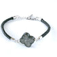 narrow braided leather bracelet with cloverleaf charm and extender chain to fit most.