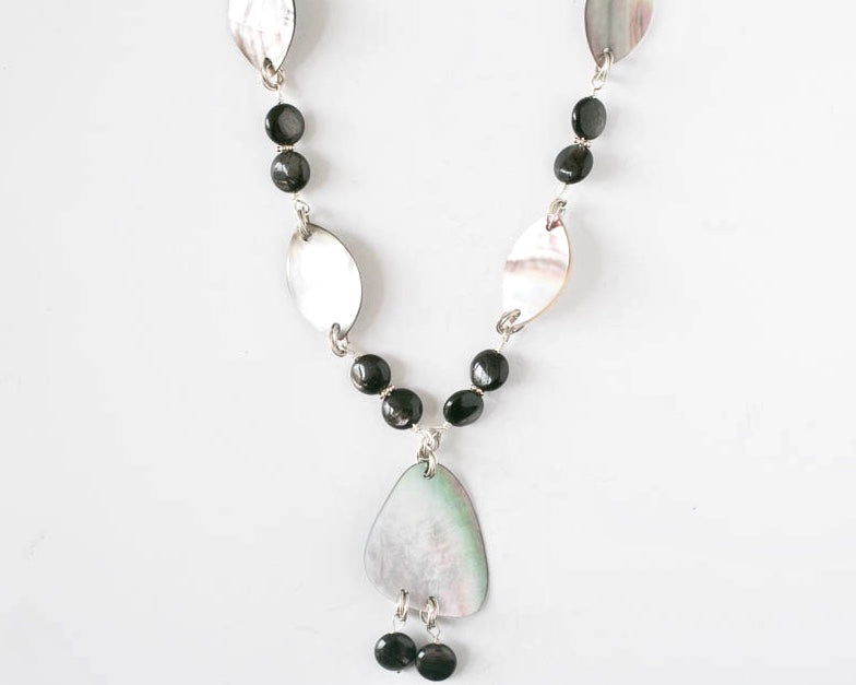 Mother of Pearl and dark agate pendant necklace and sterling silver accent. It is 17 inches long.