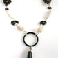 Hand made fine silver beads, leather beads and onyx focal point with tassel . 40 inches