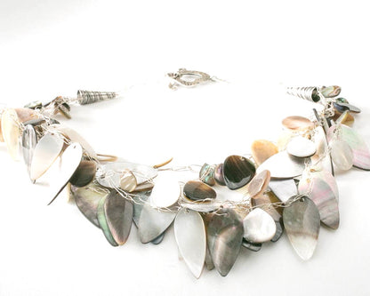 Mother of Pearl leaf shape beads handknotted with fine silver wire and a beautiful designer finish and sterling silver heart clasp.