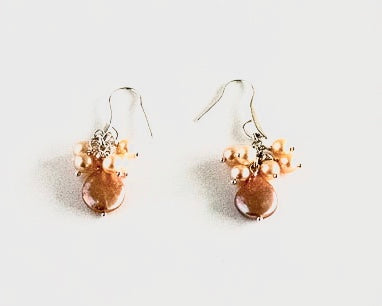 Peach colour luminscent pearls in coin and round shape on a sterling silver ear hook by Pretaporterjewels.com Jewellery that invites compliments!