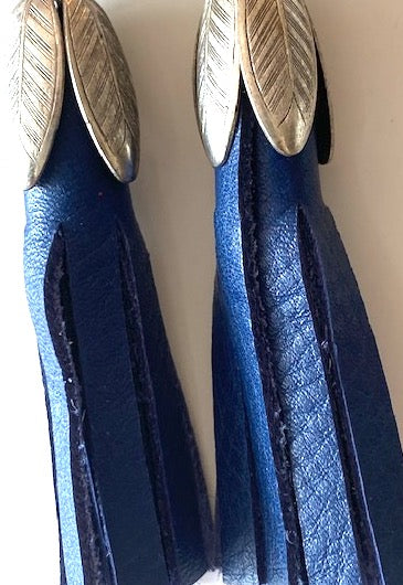 Blue leather tassel earrings with silver tulip caps. These earrings are three inches long.