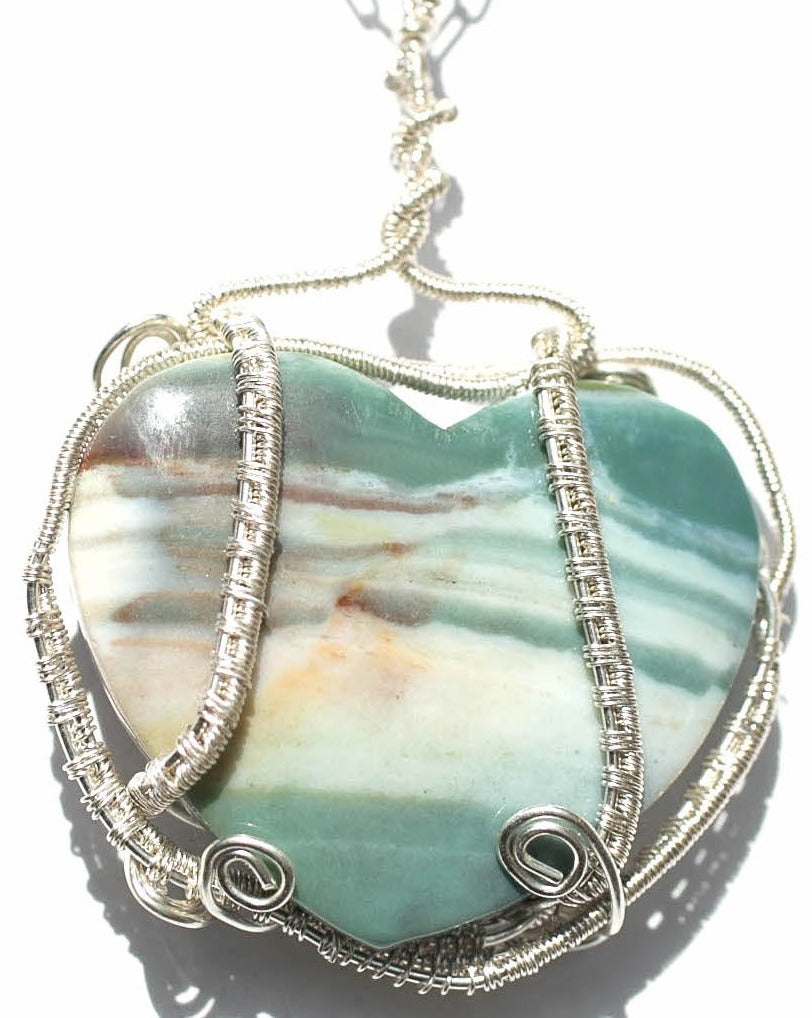 Natural jasper heart shaped pendant with fine silver woven frame on a sterling silver chain.