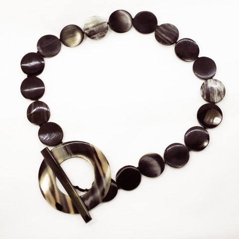 Natural colour horn round beads with large toggle that can be work on the side or in the front. It is 60cms or 26 inches long.